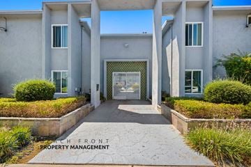 Anaheim apartment for rent - the front of a building with a walkway and a glass door