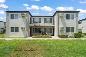 Stanton apartment for rent - A two-story building with a balcony on the second floor.