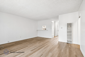 Gardena apartment for rent - A spacious room with wooden flooring and white walls.