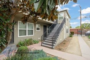 Long Beach apartment for rent - A house with a staircase leading to the front door.