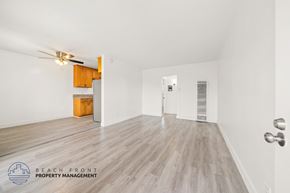 Gardena apartment for rent - A spacious room with wooden flooring and a ceiling fan.