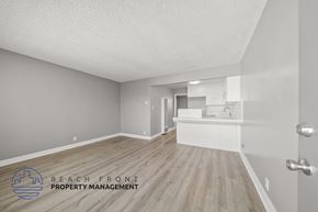Torrance apartment for rent - A room with wooden flooring and a logo for Beach Front Property Management.