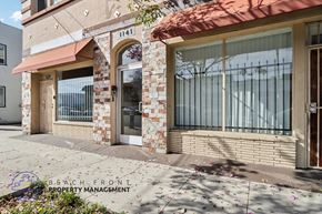Long Beach apartment for rent - A building with a red awning and a sign that says Beach Front Property Management.