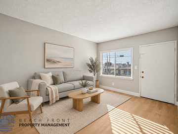 Hawthorne apartment for rent - A living room with a couch, chair, and a painting of a beach scene on the wall.