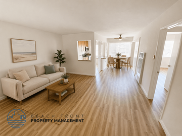 Pasadena apartment for rent - A living room with a couch, coffee table, and a painting of a beach scene on the wall.