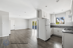 Hawthorne apartment for rent - A kitchen with a refrigerator, sink, and cabinets.