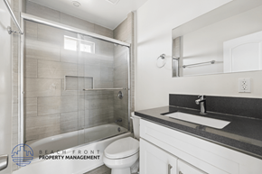 Hawthorne apartment for rent - A bathroom with a walk-in shower and a white toilet.