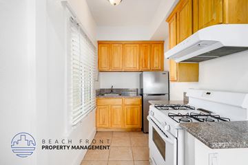 Los Angeles apartment for rent - A kitchen with a stove top oven and a refrigerator.