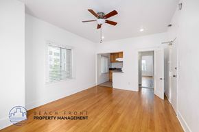 Los Angeles apartment for rent - A spacious room with wooden floors and a ceiling fan.