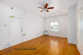 Los Angeles apartment for rent - A room with a ceiling fan and wooden floors.