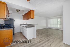 Los Angeles apartment for rent - A kitchen with wooden cabinets and a white countertop.