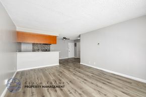 Los Angeles apartment for rent - A spacious room with wooden flooring and a fireplace with a white wall and a door in the background.