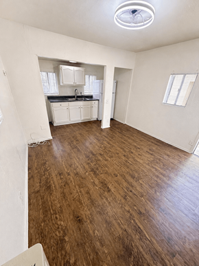 Signal Hill apartment for rent - A room with wooden flooring and white walls.