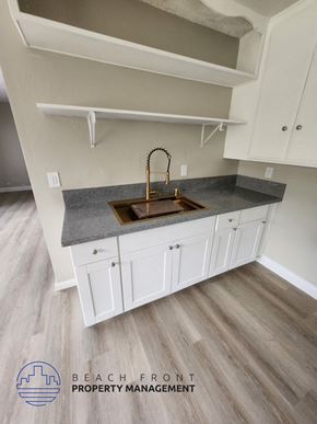 Garden Grove apartment for rent - A kitchen with white cabinets and a granite countertop.