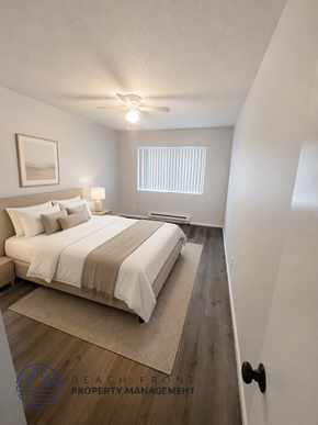 Long Beach apartment for rent - A well-lit bedroom with a large bed and a rug on the floor.