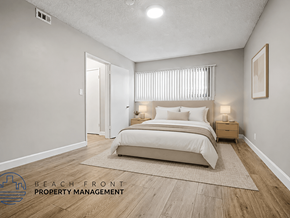 Playa Del Rey apartment for rent - A well-lit bedroom with a large bed and a nightstand with a lamp.
