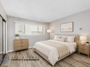 Los Angeles apartment for rent - A bedroom with a large bed, two nightstands, and a window with blinds.