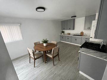 Santa Ana apartment for rent - A kitchen with a table and chairs in the middle of the room.