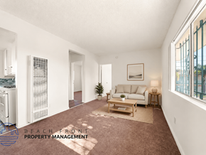 Wilmington apartment for rent - A living room with a couch, a coffee table, and a plant.