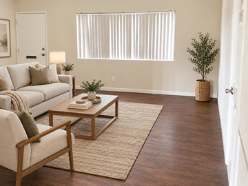 Inglewood apartment for rent - A living room with a couch, chair, and a table with a plant on it.