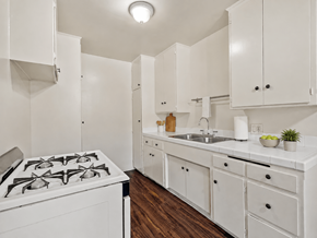 Inglewood apartment for rent - A white kitchen with a stove and cabinets.