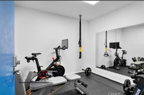 Hermosa Beach apartment for rent - a workout room with bikes and weights in a home gym