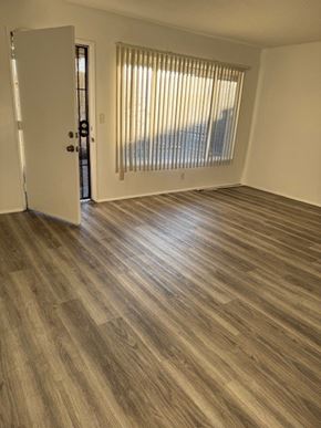 Gardena apartment for rent - A room with a white door and a window with blinds.