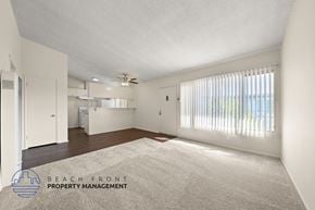 Gardena apartment for rent - A spacious room with a carpeted floor and a ceiling fan.