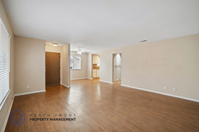 Lakewood apartment for rent - A spacious empty room with wooden floors and white walls.