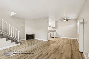 Huntington Beach apartment for rent - A spacious room with wooden flooring and a staircase leading to the upper level.