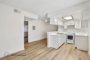 Los Angeles apartment for rent - A kitchen with white cabinets and a wooden floor.