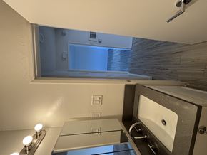 Long Beach apartment for rent - A bathroom with a sink, mirror, and a window.