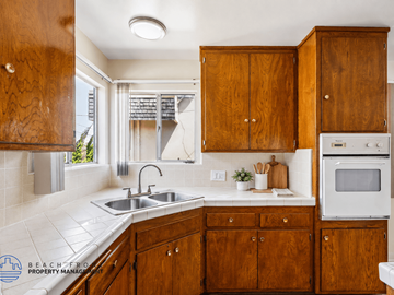 Inglewood apartment for rent - A kitchen with wooden cabinets and a white oven.