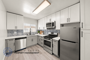 Los Angeles apartment for rent - A modern kitchen with stainless steel appliances and white cabinets.