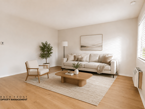 La Habra apartment for rent - A living room with a white couch, a wooden chair, a coffee table, and a plant.