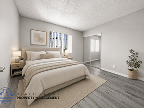 Los Angeles apartment for rent - A bedroom with a large bed and a plant in a woven basket.