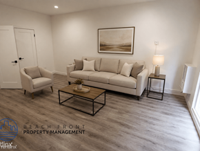 Los Angeles apartment for rent - A living room with a white couch, a chair, and a coffee table.
