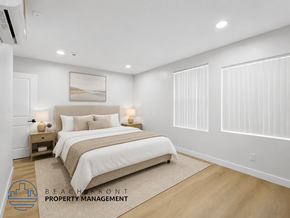 Long Beach apartment for rent - A well-lit bedroom with a large bed and a painting on the wall.