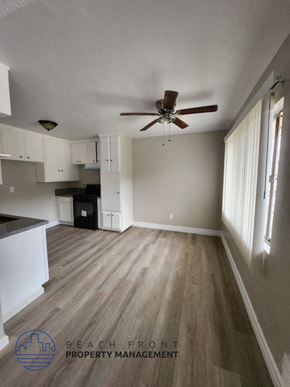 Garden Grove apartment for rent - A spacious room with a ceiling fan and wooden flooring.