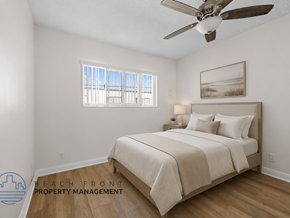 Downey apartment for rent - A bedroom with a large bed and a ceiling fan.