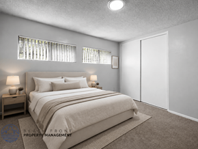 Inglewood apartment for rent - A bedroom with a large bed, two nightstands, and a carpeted floor.