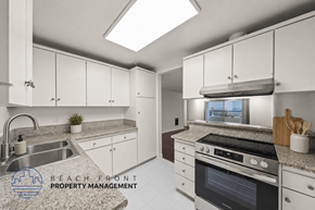 Redondo Beach apartment for rent - A kitchen with a stove, sink, and cabinets.
