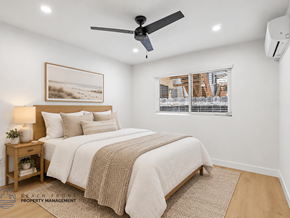 Long Beach apartment for rent - A bedroom with a bed, a ceiling fan, and a window with blinds.