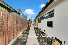Venice apartment for rent - a side view of a building with a sidewalk and a brick wall