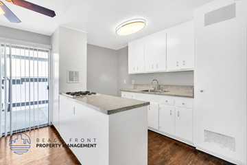 Costa Mesa apartment for rent - A kitchen with white cabinets and a countertop with a sink.