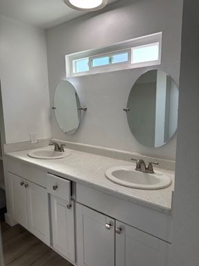 Santa Ana apartment for rent - A bathroom with two sinks and two mirrors.