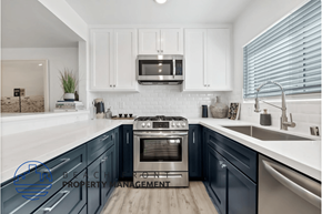 Newport Beach apartment for rent - a kitchen with blue cabinets and white counter tops and a sink