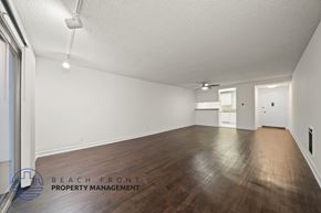 Redondo Beach apartment for rent - A spacious room with wooden floors and white walls.
