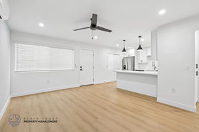 Long Beach apartment for rent - A spacious room with a ceiling fan and pendant lights.