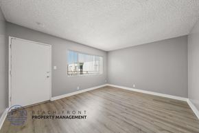Torrance apartment for rent - A room with a wooden floor and a window overlooking a building.